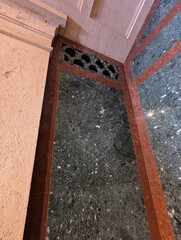 Detail of a granite wall with fancy borders and shiny texture