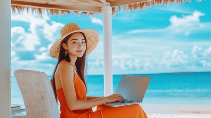 Wall Mural - Woman working on a laptop on a tropical beach