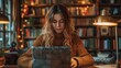 © kramynina - Woman sitting at a table using a laptop computer in a library, woman in business casual attire