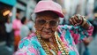 © Dulemegapixel - An elderly woman full of zest poses confidently in vibrant streetwear, exuding unstoppable energy with her playful style and fashionable accessories.