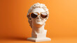 © Natalia - Classical marble bust wearing modern orange sunglasses against an orange background. The combination creates a mix of classical art and contemporary fashion style.