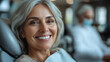© Alex Alex - An elderly woman in a dental clinic smiles with a smile with white even teeth. Appointment with a dentist.