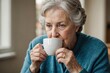 © ThomasLENNE - Portrait of senior woman drinking from cup