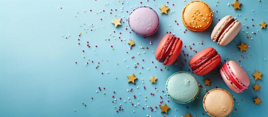 Wall Mural - Colorful macaroons on a blue background with small stars Top view flat lay style. Copy space image. Place for adding text and design