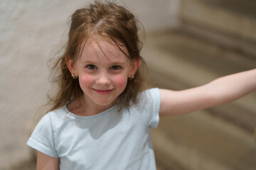 Little cute girl walking on stairs holding handrail. Children's exploration concept