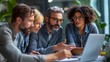 © sungedi - Four Colleagues Collaborating on a Laptop in a Modern Office Setting