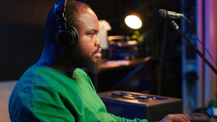 Leinwandbilder - Music composer plays electronic keyboard piano keys and recording new tracks, creating audio recordings before launching music. Artist producer uses synthesizer, post production. Camera A.
