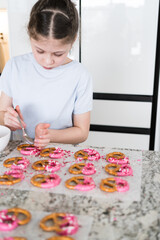 Wall Mural - Young Chef Prepares Chocolate-Covered Treats in Sunny Kitchen