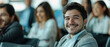 © Diversity - photo of a young, latin, happy businessman (22 years old) sitting listening to a business conference.