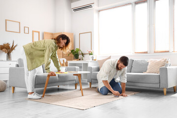happy couple in love cleaning at home