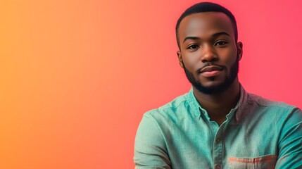 Wall Mural - Portrait of a Black Man in a Green Shirt Against a Pink Background