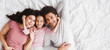© Prostock-studio - Family rest. Happy mother, father and cute little daughter lying on bed together, cuddling and relaxing at home, top view