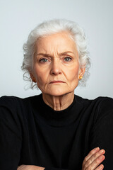 an elderly Caucasian woman with an annoyed expression, set against a white backdrop