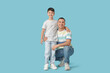 © Pixel-Shot - Cute little boy with his father on blue background