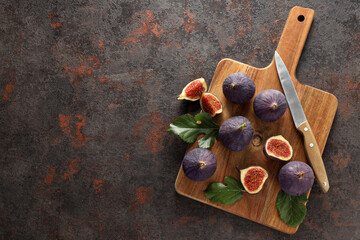 Sticker - Fresh ripe figs with a knife on a wooden board