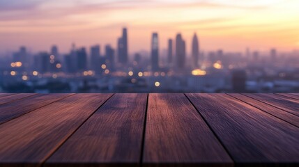 Canvas Print - A wooden table in the foreground with a blurred city skyline at sunset.