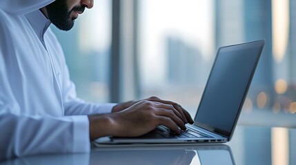 Managing Business Affairs with Technology: Saudi Arabian Gulf Businessman Completing Work Tasks on Laptop