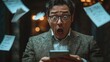 © PJ Gallery - Man in Shock While Looking at Phone Surrounded by Papers