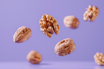 Super food, healthy food snack levitate for advertisement concept. Flying levitating in air fresh raw whole and cracked walnut nuts isolated on purple background