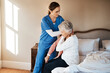 © Malambo/peopleimages.com - Nurse, senior woman and dressing in bedroom, support and trust with rehabilitation, recovery and healing. House, medical and professional with patient, caregiver and health with comfort or assistance