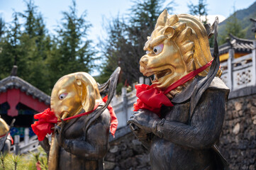 Wall Mural - The bronze statues with animal head situated in Jade water village in Lijiang, China.