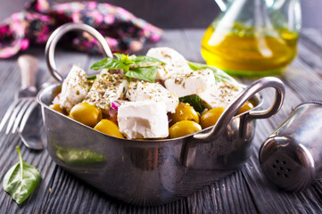 Wall Mural - Greek salad with tomatoes, feta cheese, cucumbers, onions and olives