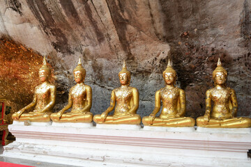 sculptures of a seated buddha at wat phra phutta chai, saraburi province.