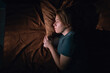© Andrii Lysenko - Young sad woman lying in bed late at night trying to sleep suffering insomnia. Girl in bed scared on nightmares looking worried and stressed. Sleeping disorder and insomnia