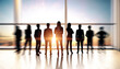 © Who is Danny - Crowd of backlit men and businesswomen in blurry office with panoramic city and sky view. Team, future and success concept. Double exposure.