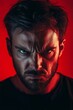 © Yeivaz - Man displays a fierce and intense expression of anger on red backdrop