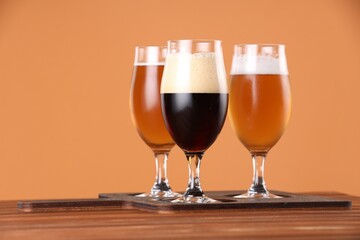 Sticker - Glasses with different types of beer on wooden table