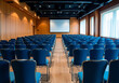 © Paulrommer - Empty conference hall with blue chairs Rear view