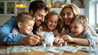 © AnastasiiaCherkas - Happy Family Teaching Children About Savings Around a Table with Piggy Bank