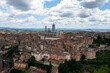 © AmazingAerialAgency - Aerial view of the historic old town with medieval architecture and beautiful cathedral, Siena, Italy.