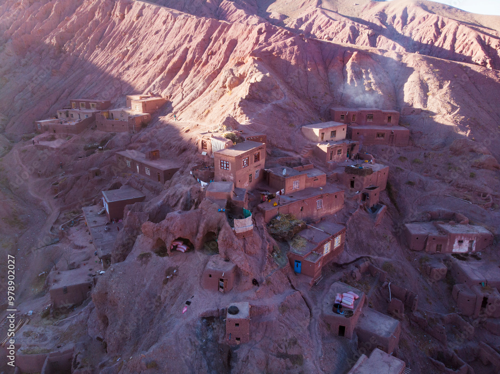 Aerial view of a remote mountain village with traditional adobe houses ...