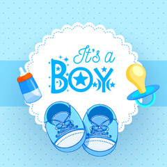 Canvas Print - Baby shoes with pacifier and baby bottle on blue background for It's a Boy.