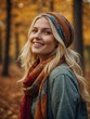 © Tamazina - Young Caucasian woman with long blonde hair wearing colorful headband and scarf, smiling in autumn forest setting