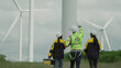 © Montri - A group of wind turbine engineers plans to monitor wind turbine operation and maintenance in a wind farm, a sustainable energy industry concept.