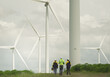 © Montri - engineering technicians supervise wind power wind turbines during a sunny and windy day. Renewable and sustainable energy, technology applied to the circular green economy, expert and professional