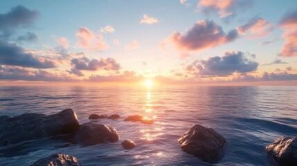 Calm ocean water with pink sunset sky and dark rocks.