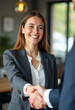 © PREM - Happy young professional business woman handshaking client at meeting, female hr recruiter at job interview, insurance agent, lawyer at contract deal, project deal