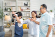 © Art_Photo - Asian family playing together with virtual reality headset in living room, grandmother guiding young girl wearing vr glasses, family bonding activity, modern technology, interactive learning at home