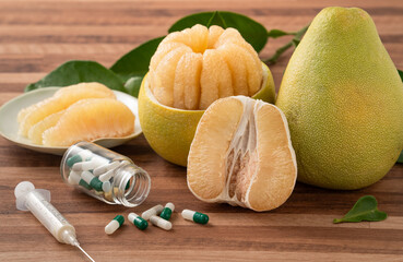 Fresh pomelo fruit and medicine adverse drug reaction interaction design concept.