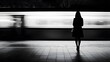 © Sebastian - A woman stands on the platform of an underground station, holding her handbag and waiting for the train to arrive