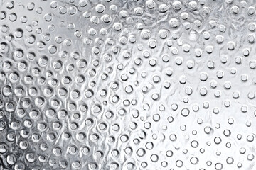 Wall Mural - gray metallic silver shiny light abstract background with a rough surface, polka dots. Shiny foil, platinum.