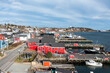 © AmazingAerialAgency - Aerial view of colorful buildings and boats in a charming fishing village by the ocean, Lunenburg First South, Canada.