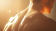 © Tin - A close-up of a person's muscular back glistening under soft light, showcasing strength and beauty with a warm, captivating glow.