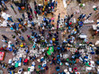 © AmazingAerialAgency - Aerial view of bustling fishery market with vibrant vendors and buyers, Chittagong, Bangladesh.