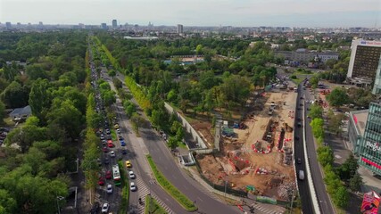 Wall Mural - Drone aerial 4k video landscape over Bucharest. Kiseleff boulevard during rush hour traffic, Arch of Triumph and other landmarks in Bucharest, Romania, during a beautiful sunny day.