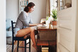 © Frank Coop/peopleimages.com - Woman, typing and happy with laptop in home with thinking, barefoot and reading email in morning. Person, computer and writer with remote work, project and review with creative career at apartment